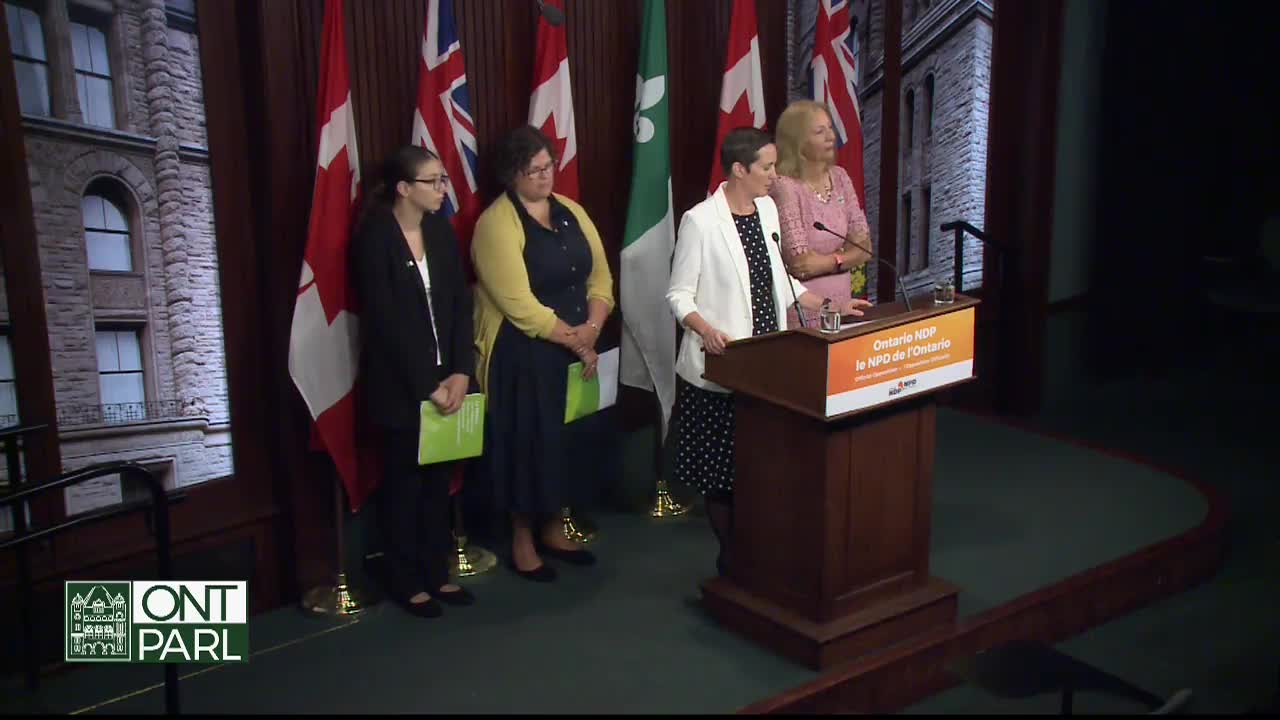 At the Legislative Assembly of Ontario, a woman in a white blazer speaks from a podium, while three others stand behind her. The flags of Canada and Ontario are visible in the background.
