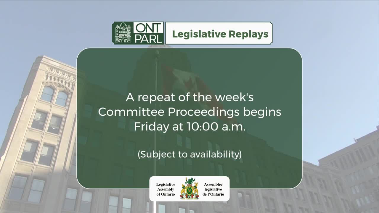 A screen announces the Legislative Assembly of Ontario's committee proceedings replay, set to air on Friday at 10:00 a.m. The Canadian flag waves atop a building in the background.
