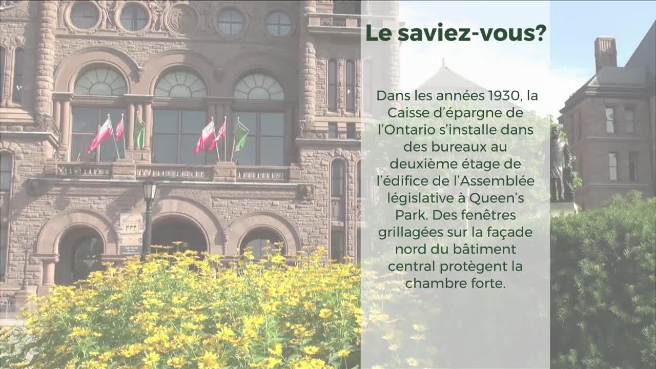 The Ontario Legislative Assembly building stands tall, its stone facade adorned with flags waving gently in the breeze. Below, a vibrant bed of yellow flowers frames the historic structure.
