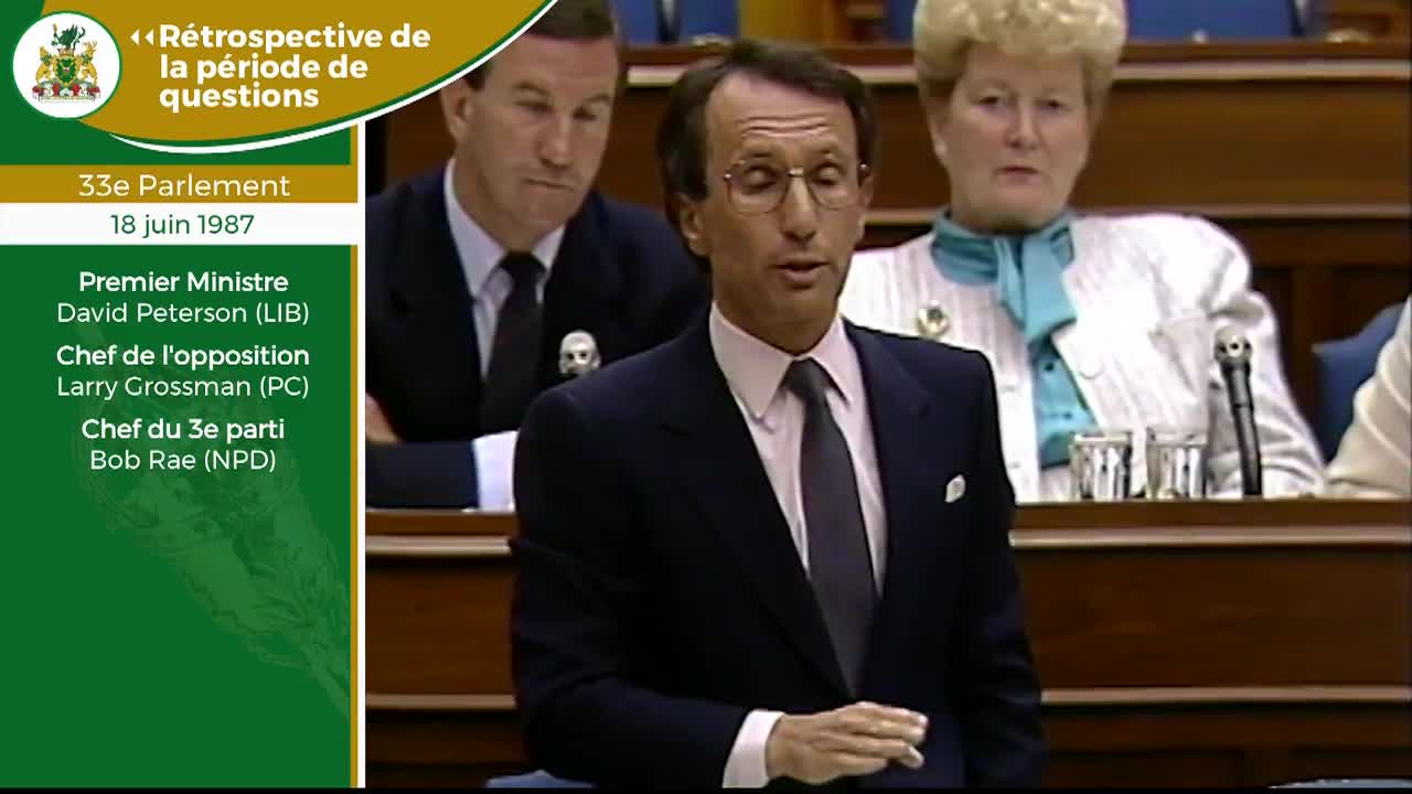 The Premier, David Peterson, speaks in the Legislative Assembly of Ontario. He gestures with his right hand as he addresses the chamber.