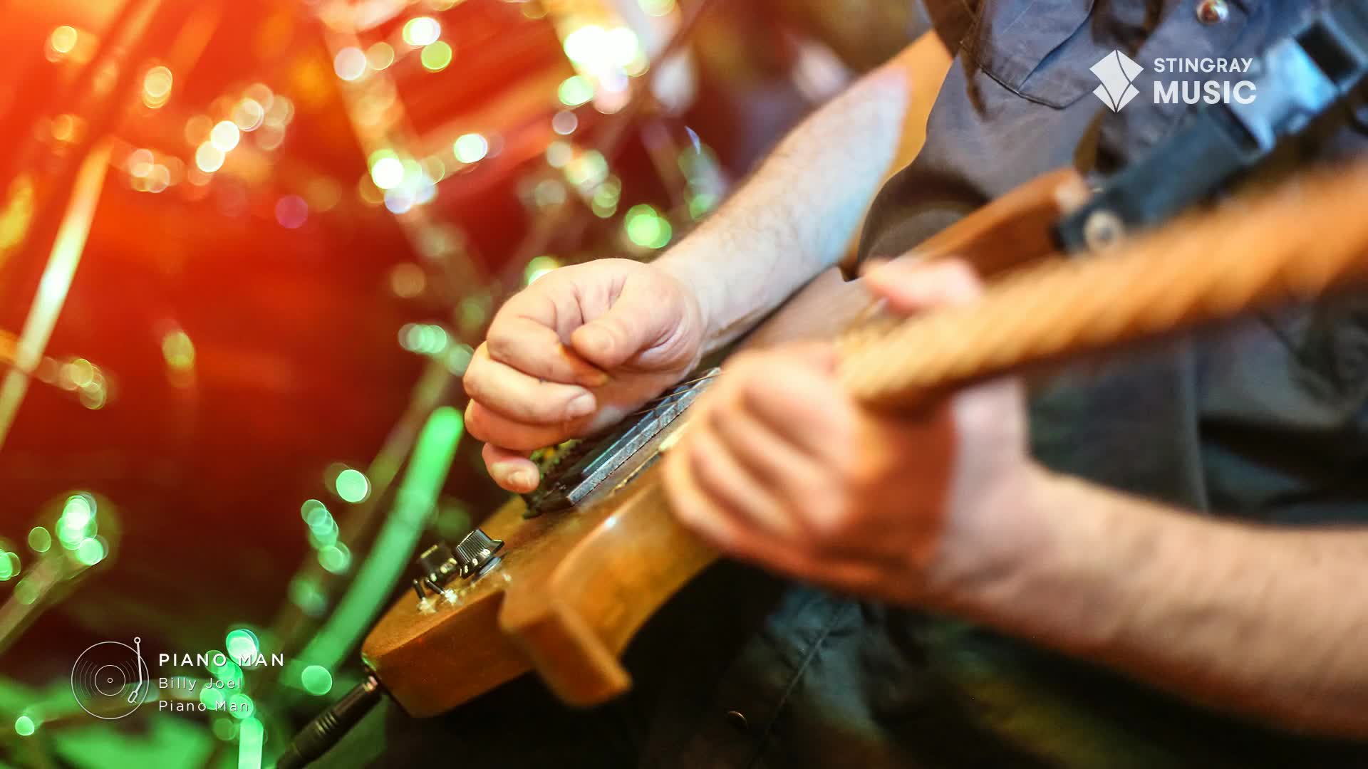 The guitarist's fingers dance across the fretboard, a well-worn instrument in hand. The stage lights, like the music on Stingray Classic Rock, are warm and vibrant.
