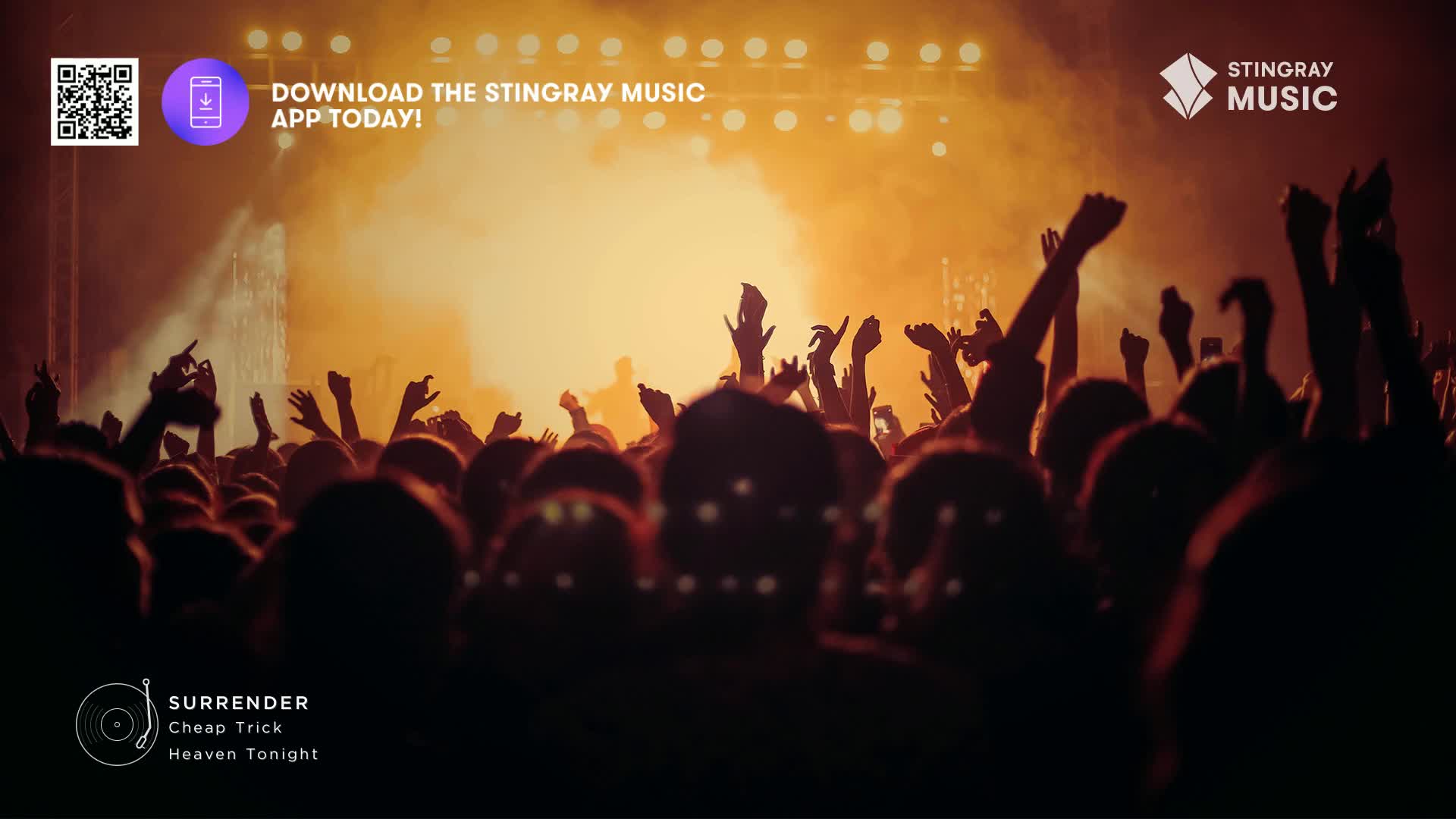 The crowd's arms are raised, reaching toward the bright lights. A classic rock anthem is playing, and the energy is palpable.
