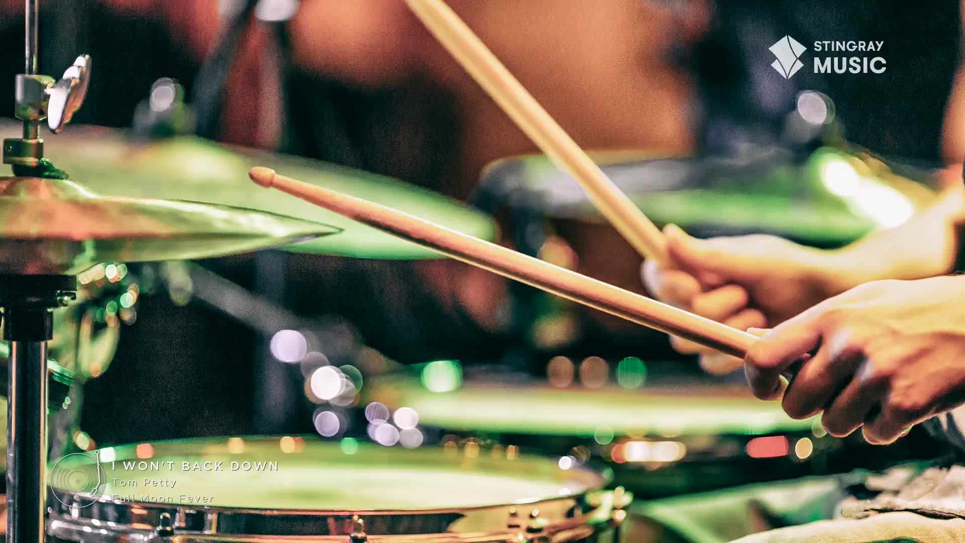 The drummer's hands are a blur, the wooden sticks striking the cymbals in time with the music. It's a classic rock anthem from Tom Petty, playing on Stingray Music Canada.
