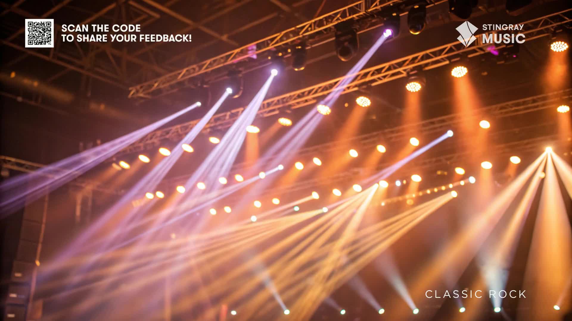 Bright beams of light, in hues of purple and orange, cut through the air from the stage lighting. The Stingray Music logo and "Classic Rock" text are visible, hinting at the show's genre.
