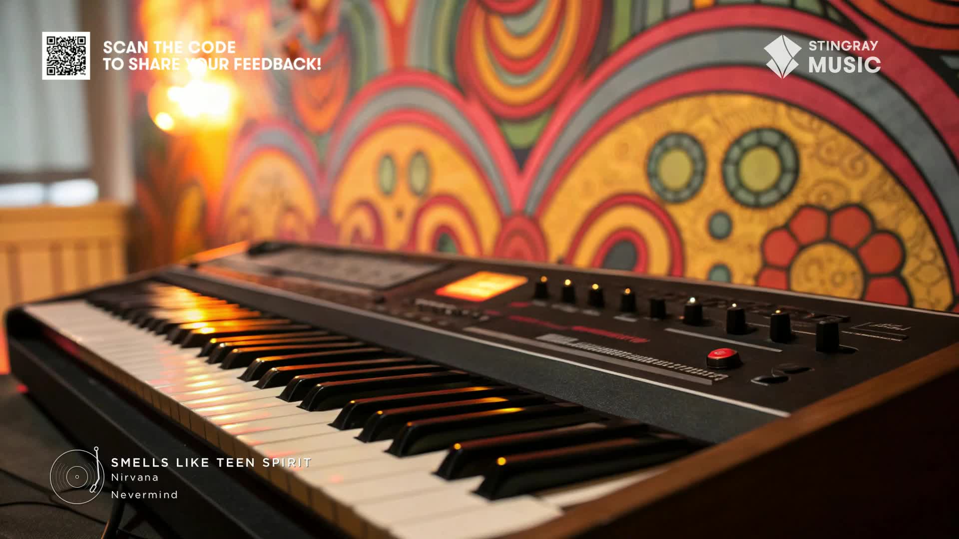 A keyboard, likely for a Stingray Classic Rock session, sits in the foreground with the keys reflecting warm light. Behind it, a colorful, retro-style wall provides a vibrant backdrop.
