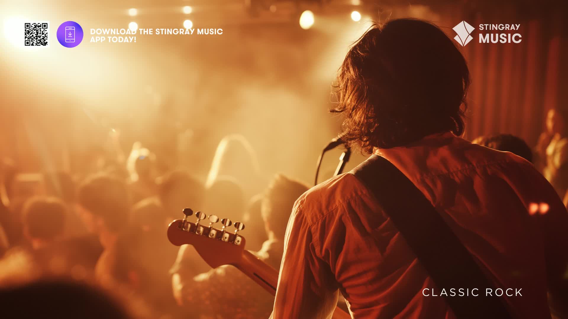 The guitarist, bathed in stage light, strums a Fender Stratocaster.  Behind him, a crowd of people, silhouetted in the warm glow, are clearly enjoying the Stingray Classic Rock show.

