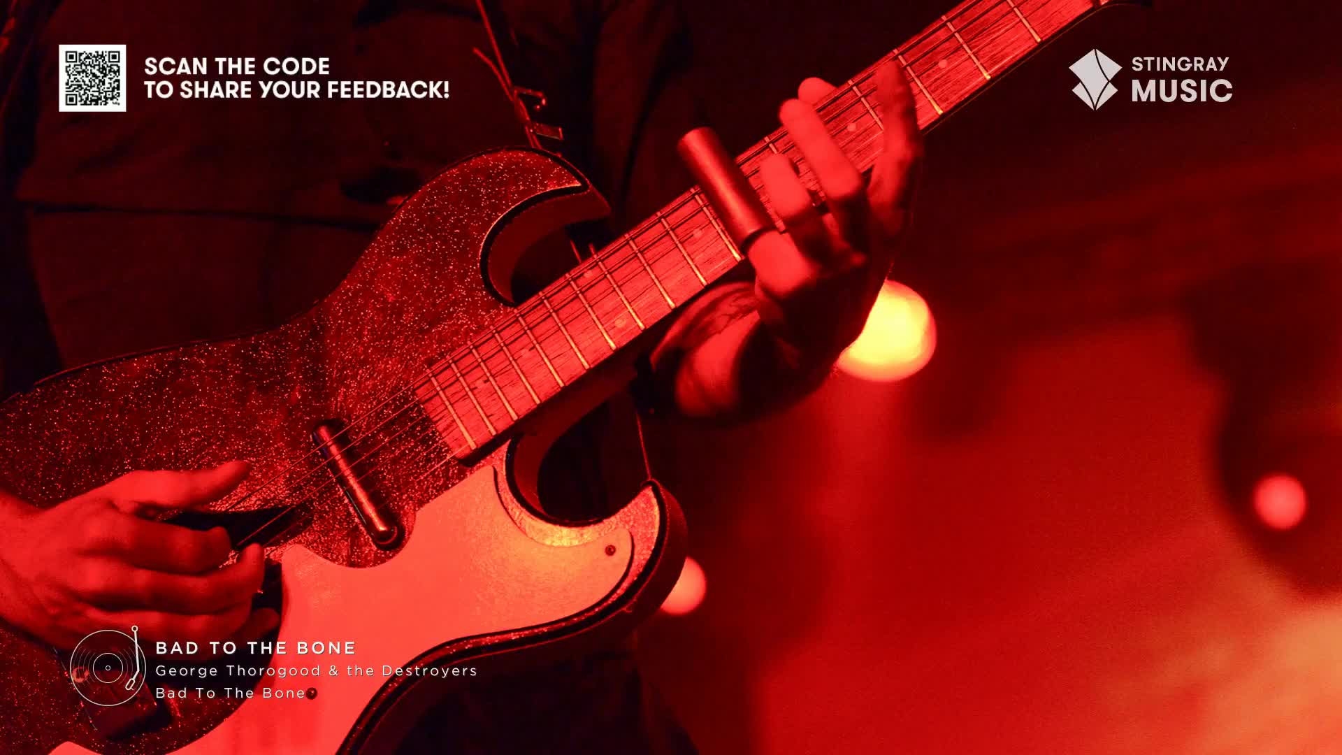 The guitarist's fingers dance across the frets, the red stage lights reflecting off the shimmering guitar. A Stingray Classic Rock tune, "Bad to the Bone," fills the air, a quintessential Canadian rock anthem.
