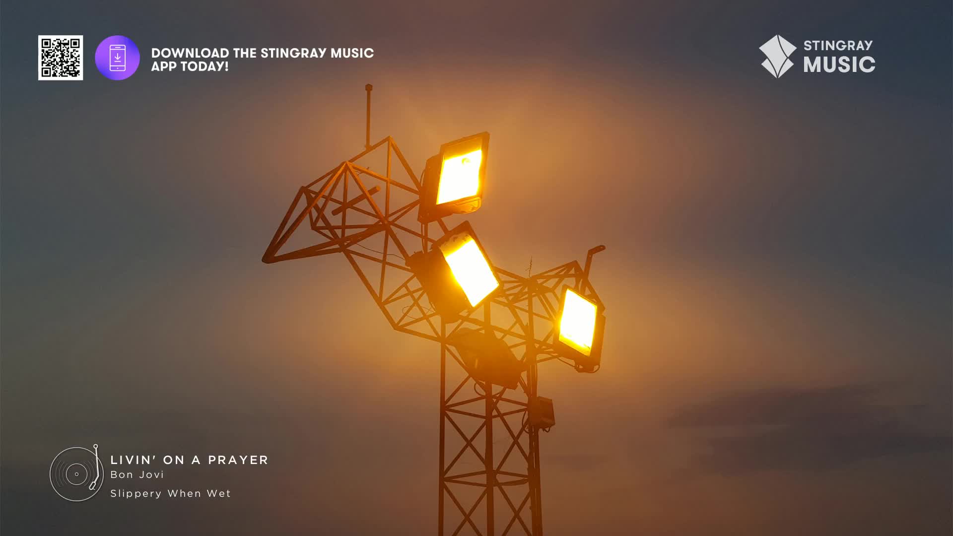 The floodlights on the metal tower are blazing, casting a warm glow against the darkening sky. "Livin' on a Prayer" by Bon Jovi, playing on Stingray Classic Rock, feels right for this moment.
The floodlights on the metal tower are blazing, casting a warm glow against the darkening sky. "Livin' on a Prayer" by Bon Jovi, playing on Stingray Classic Rock, feels right for this moment.