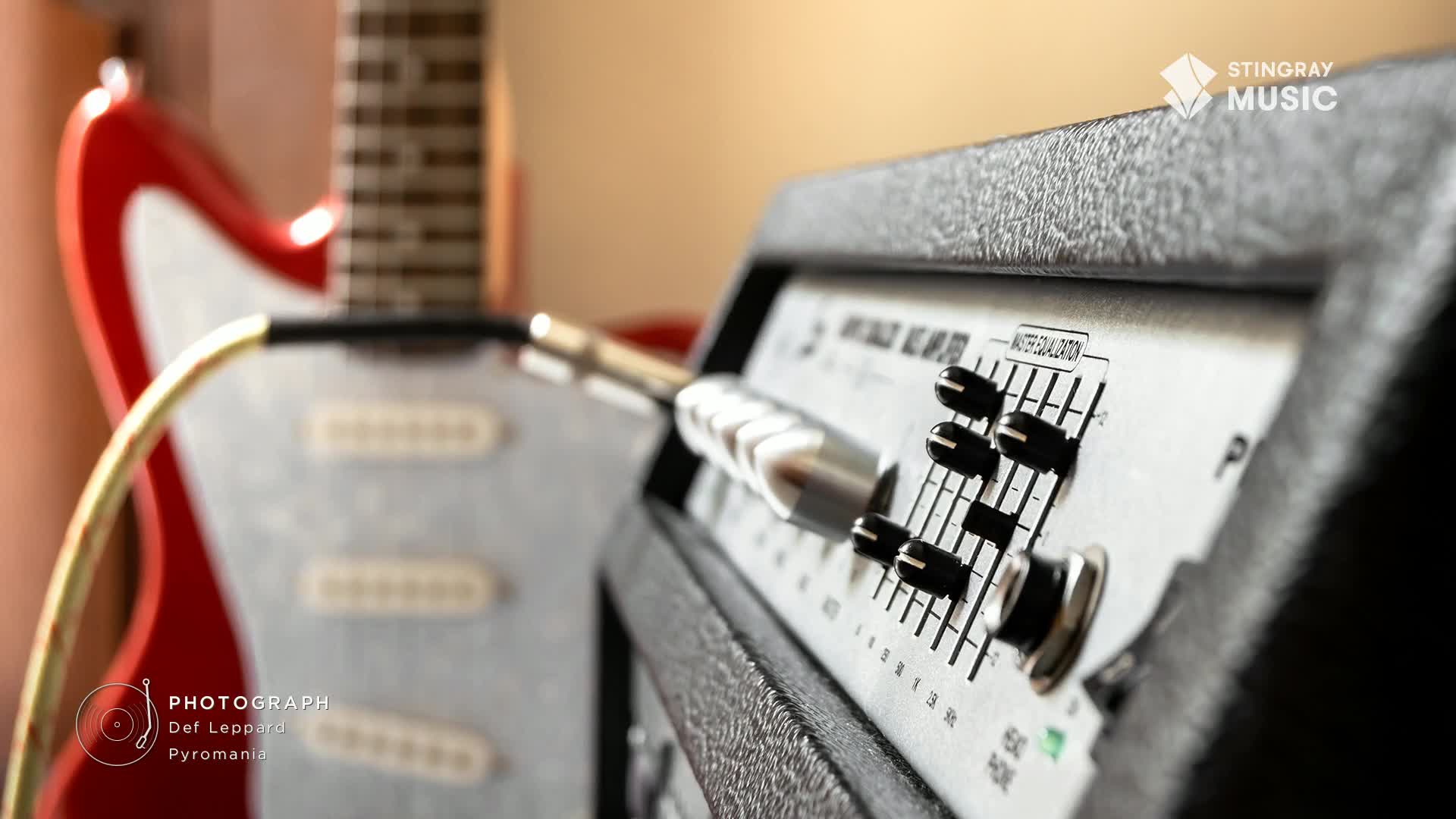 A red guitar, slightly out of focus, is plugged into an amplifier, ready to blast through your speakers. The amp's control panel, with its knobs and dials, is set for some classic rock from Stingray Music Canada.
A red guitar, slightly out of focus, is plugged into an amplifier, ready to blast through your speakers. The amp's control panel, with its knobs and dials, is set for some classic rock from Stingray Music Canada.