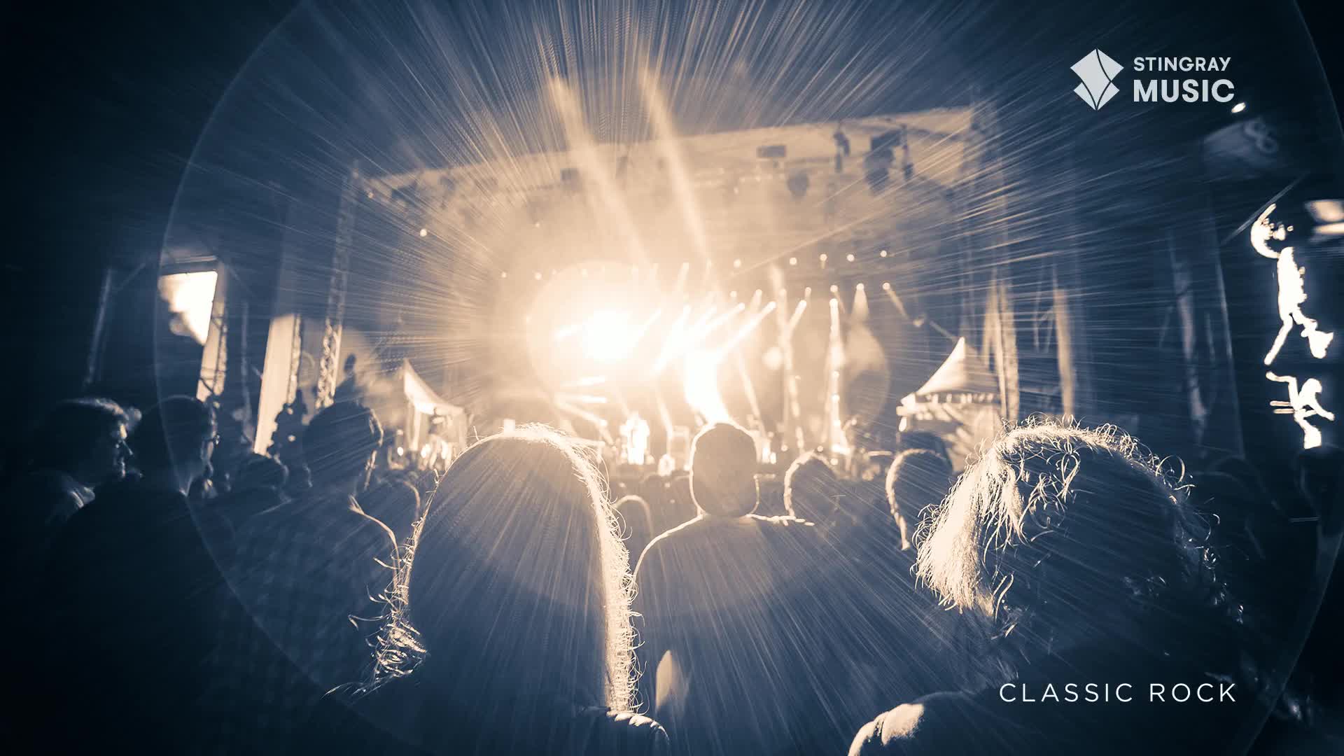 The crowd is silhouetted, facing a stage illuminated by bright lights. It's a classic rock concert, presented by Stingray Music in Canada, and the energy is palpable.

