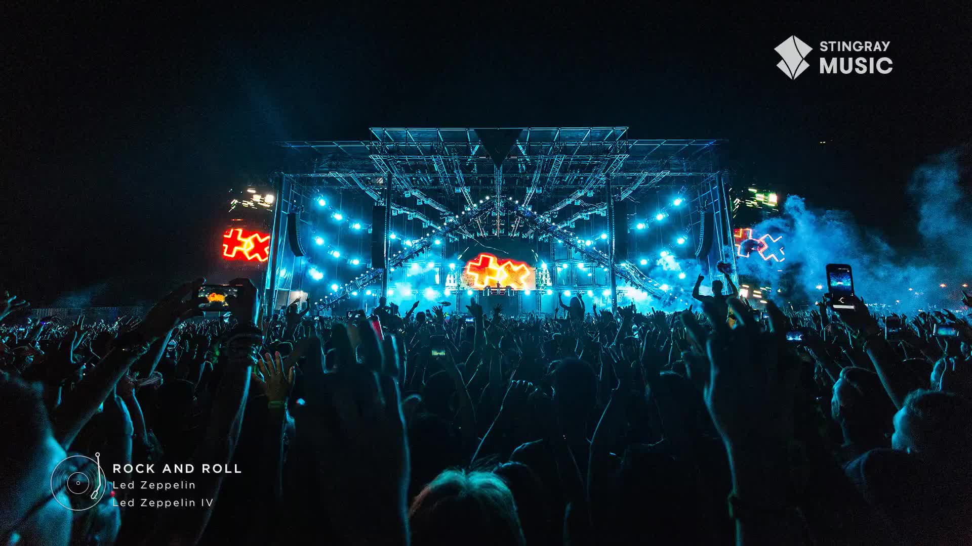 The stage is lit up with bright blue lights, and the crowd is a sea of raised arms and phones. It's a classic rock night in Canada, courtesy of Stingray, and the energy is electric.
