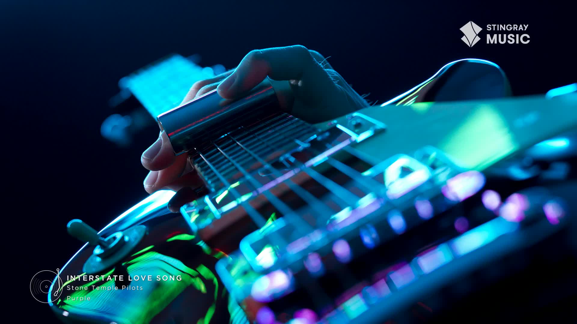 A hand slides a chrome bar across the strings of a guitar, the instrument's body reflecting the stage lights. The song, "Interstate Love Song," from Stone Temple Pilots, is coming through the speakers on Stingray Classic Rock.
A hand slides a chrome bar across the strings of a guitar, the instrument's body reflecting the stage lights. The song, "Interstate Love Song," from Stone Temple Pilots, is coming through the speakers on Stingray Classic Rock.