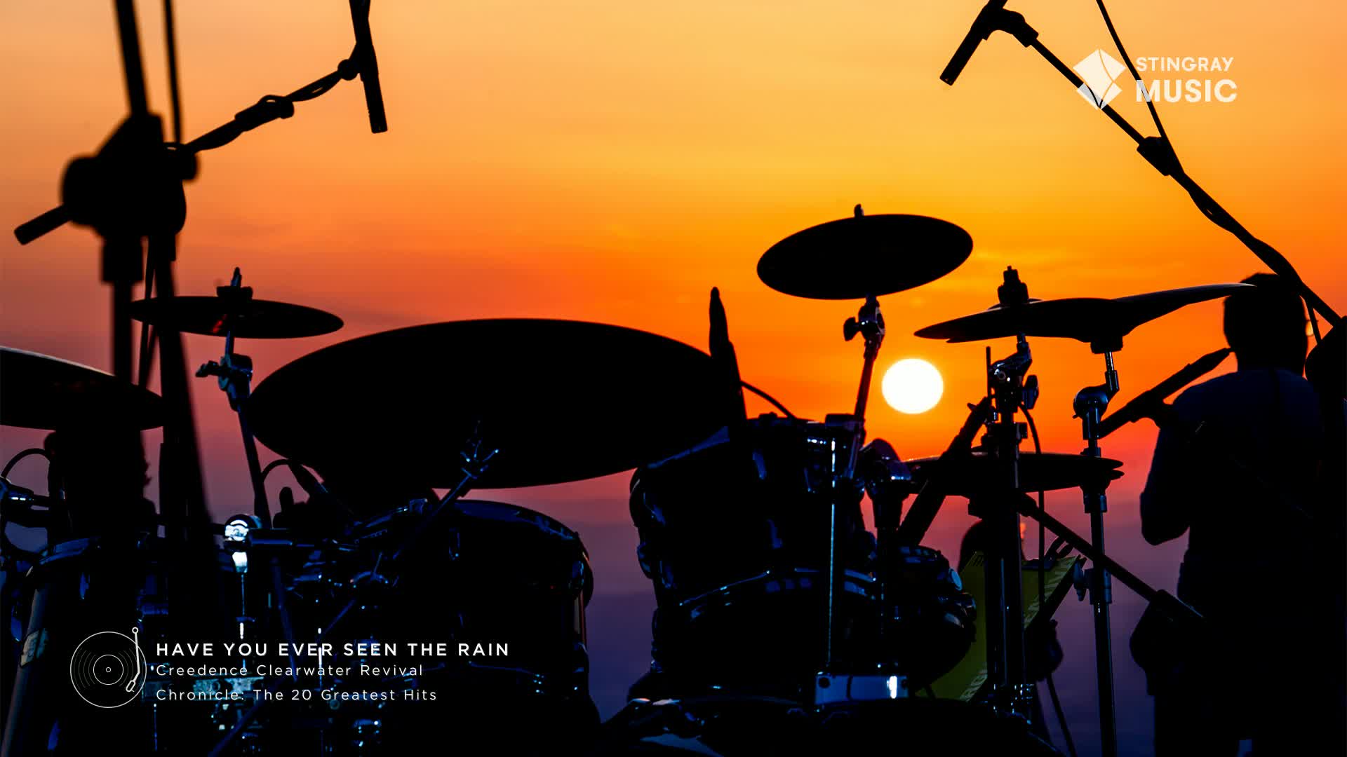 The silhouette of the drum kit stands out against the fiery sunset, ready for a Creedence Clearwater Revival classic on Stingray Classic Rock. The drummer's arms are poised, ready to bring the music to life under the Canadian sky.
The silhouette of the drum kit stands out against the fiery sunset, ready for a Creedence Clearwater Revival classic on Stingray Classic Rock. The drummer's arms are poised, ready to bring the music to life under the Canadian sky.