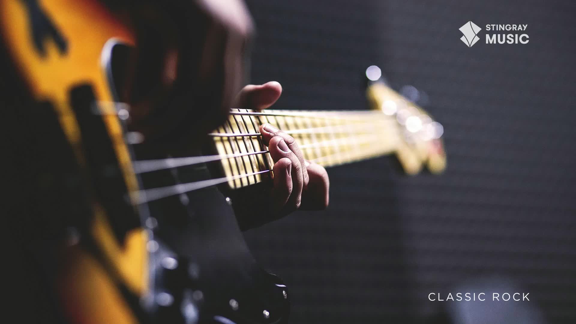 Fingers press down on the strings of a sunburst bass guitar, the neck stretching out into the dim light. This is the sound of classic rock, a staple of Canadian radio.