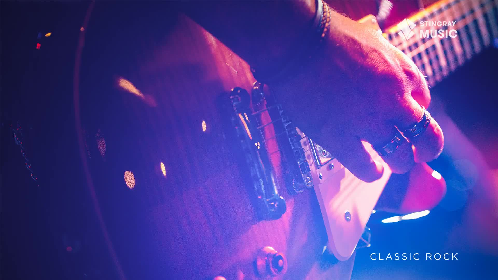 Fingers dance across the fretboard of a sunburst guitar, bathed in the purple and pink glow of stage lights. The sound of classic rock fills the air, a familiar anthem from Canada.