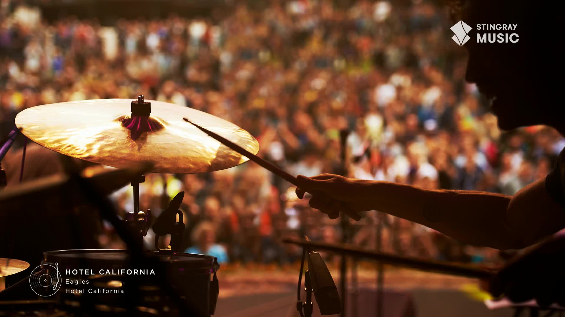 The drummer's stick is poised to strike the cymbal as the crowd in Canada roars.  This classic rock anthem, "Hotel California," is about to hit its peak.