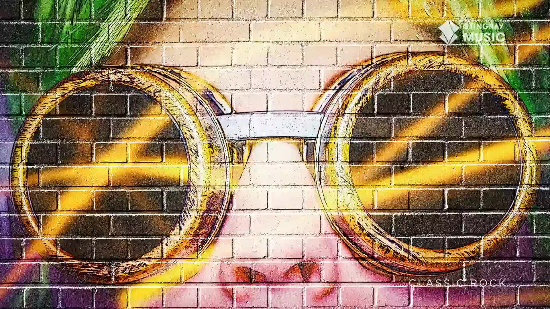 A person wearing large, round sunglasses is looking out from behind a brick wall. The lenses reflect bright yellow light, creating a striking contrast against the dark brick.