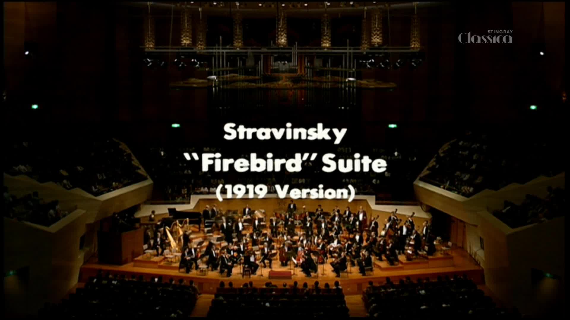 The orchestra, lit by warm stage lights, is poised, ready to play Stravinsky's "Firebird" Suite.  A Stingray Classica logo sits in the corner, broadcasting the performance in Canada.
