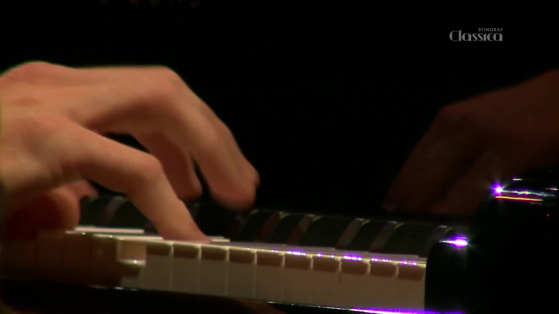 Fingers dance across the piano keys, striking the ivory and black with precision.  The scene, broadcast on Stingray Classica, is bathed in a soft, dark light.
