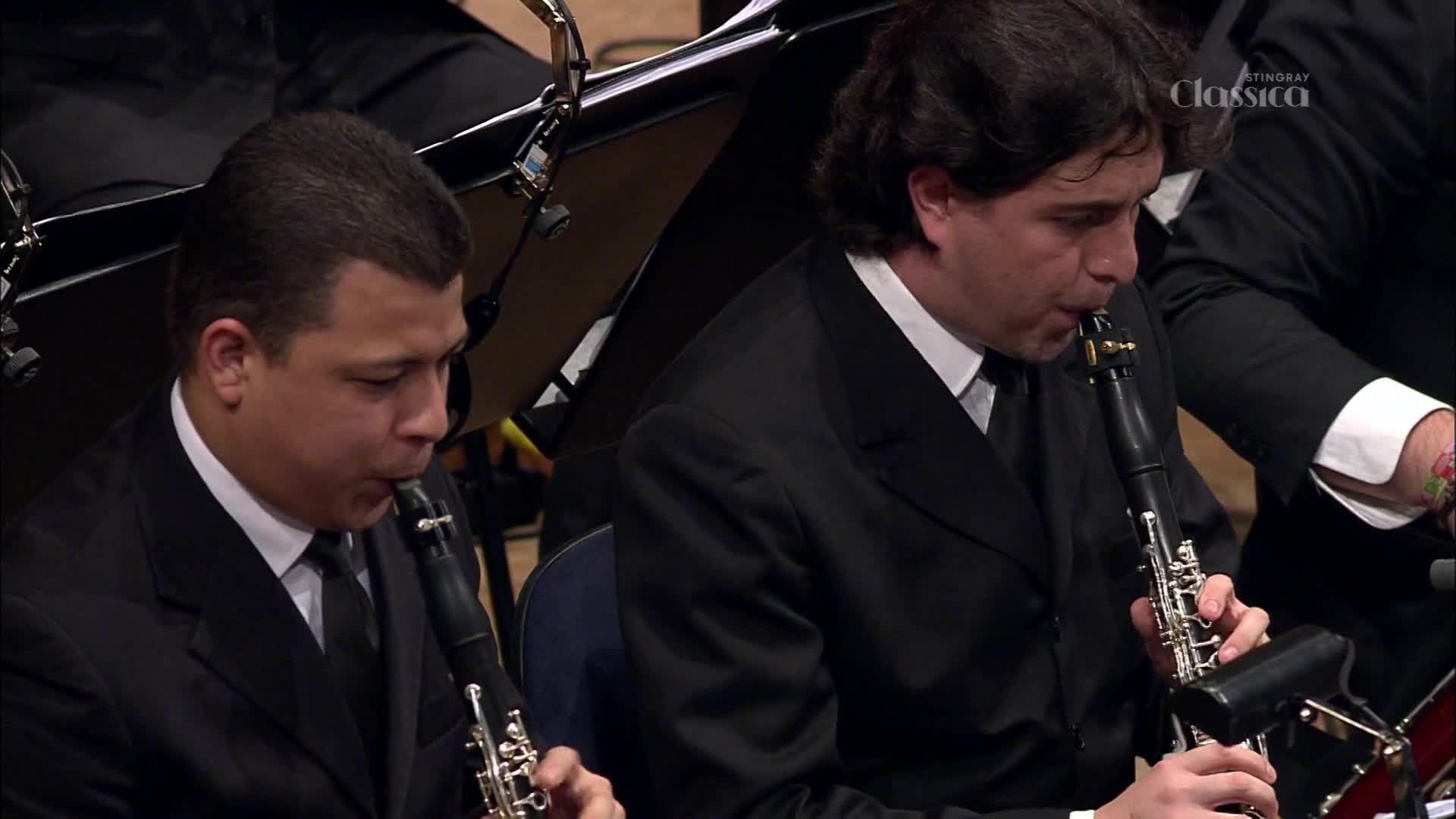 Two musicians in black suits play clarinets, their fingers moving nimbly over the keys. The Stingray Classica logo is visible in the background, hinting at a broadcast from Canada.
