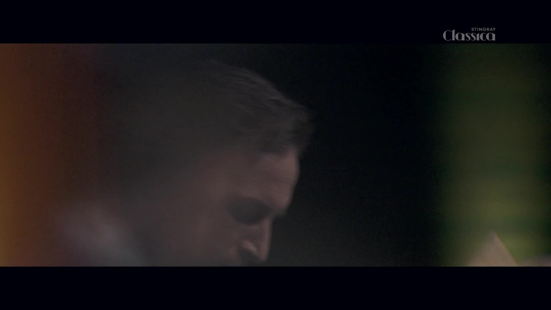 A man's face, partially obscured by shadow, leans forward. The Stingray Classica logo appears in the top right corner.