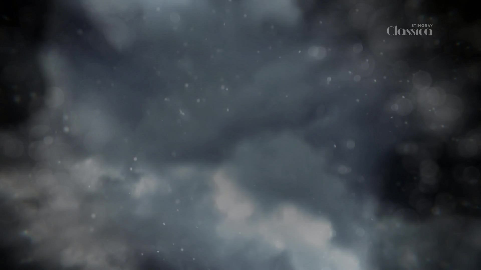 Dark clouds gather overhead, with tiny specks of light drifting down. The Stingray Classica logo appears in the upper right corner.