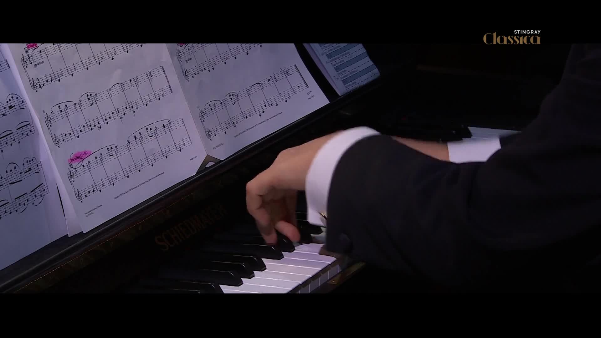Fingers dance across the piano keys, following the intricate markings on the sheet music. The Stingray Classica logo is subtly visible in the corner, hinting at a sophisticated performance. Fingers dance across the piano keys, following the intricate markings on the sheet music. The Stingray Classica logo is subtly visible in the corner, hinting at a sophisticated performance.