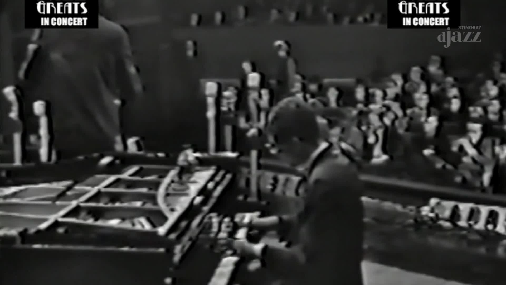 A man in a suit is focused on the organ keys, his hands moving quickly. The audience sits in rows behind him, watching the performance from Canada on Stingray DJAZZ.
A man in a suit is focused on the organ keys, his hands moving quickly. The audience sits in rows behind him, watching the performance from Canada on Stingray DJAZZ.