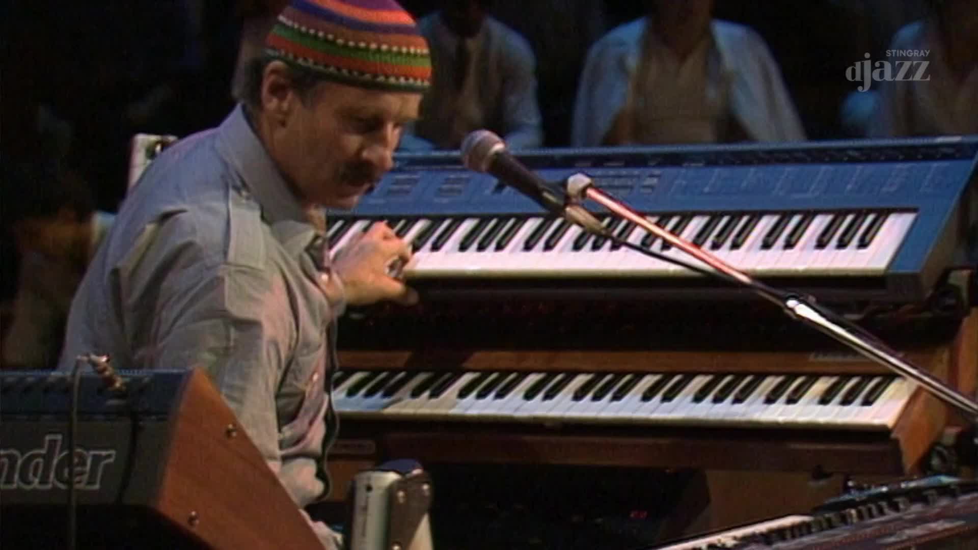 The keyboardist, wearing a colorful cap, has his fingers poised above the keys. The Stingray DJAZZ logo is visible, and the music is coming from Canada.
The keyboardist, wearing a colorful cap, has his fingers poised above the keys. The Stingray DJAZZ logo is visible, and the music is coming from Canada.