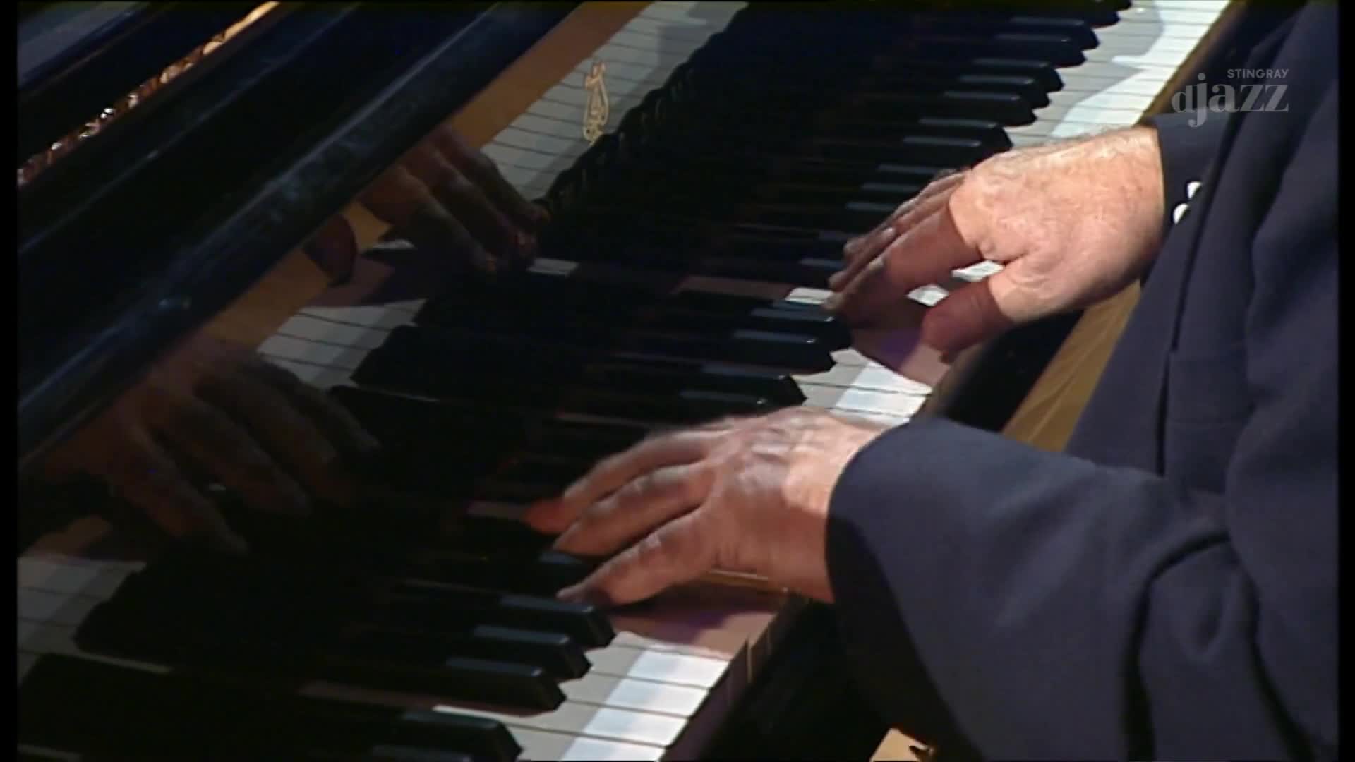A pianist's hands dance across the keys, the polished surface reflecting his movements. The music, broadcast on Stingray DJAZZ from Canada, fills the space with its rich tones.
A pianist's hands dance across the keys, the polished surface reflecting his movements. The music, broadcast on Stingray DJAZZ from Canada, fills the space with its rich tones.