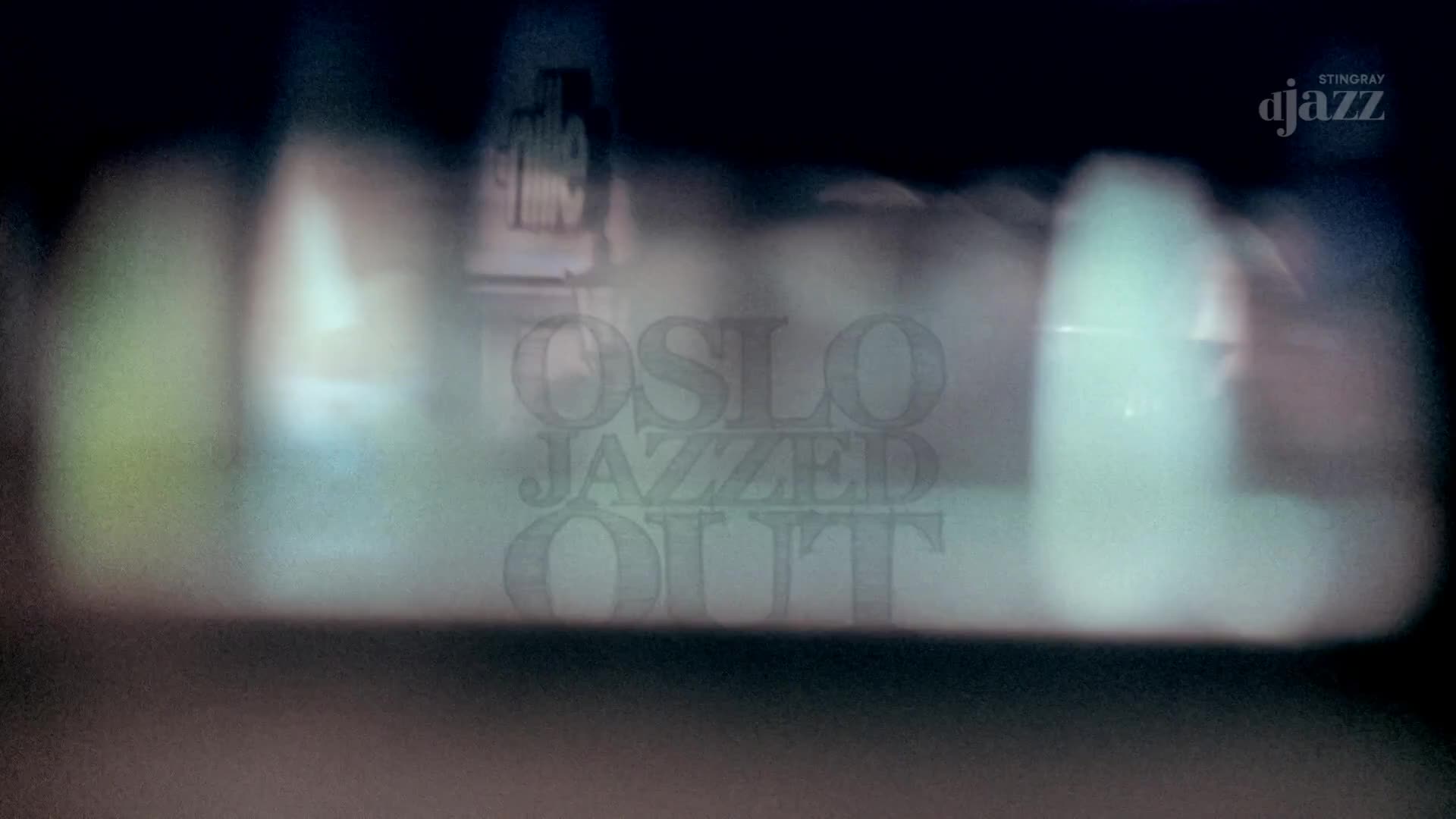 The words "OSLO JAZZED OUT" are faintly visible, superimposed over glowing, out-of-focus lights. A Stingray DJAZZ logo sits in the upper right corner. The words "OSLO JAZZED OUT" are faintly visible, superimposed over glowing, out-of-focus lights. A Stingray DJAZZ logo sits in the upper right corner.