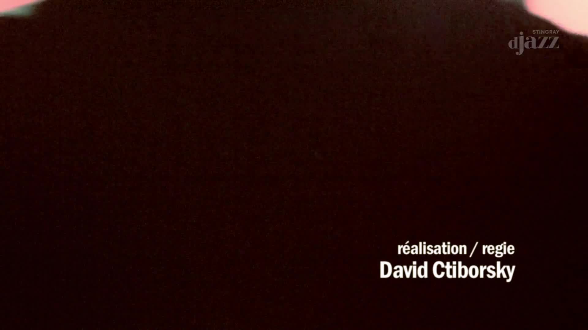 A dark, abstract shape fills the frame, with the Stingray DJAZZ logo in the upper right. Text at the bottom reads "réalisation / regie David Ctiborsky." A dark, abstract shape fills the frame, with the Stingray DJAZZ logo in the upper right. Text at the bottom reads "réalisation / regie David Ctiborsky."