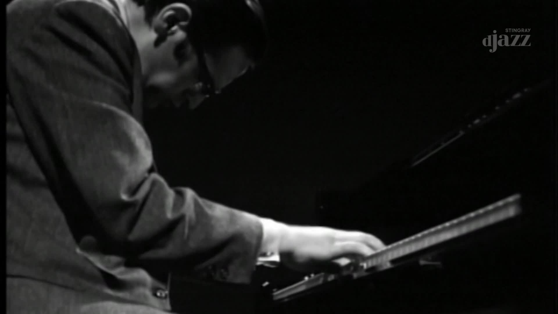 Fingers dance across the piano keys, a blur of motion against the polished ebony. The music, broadcast by Stingray DJAZZ, fills the dark room as the performer leans into the melody.