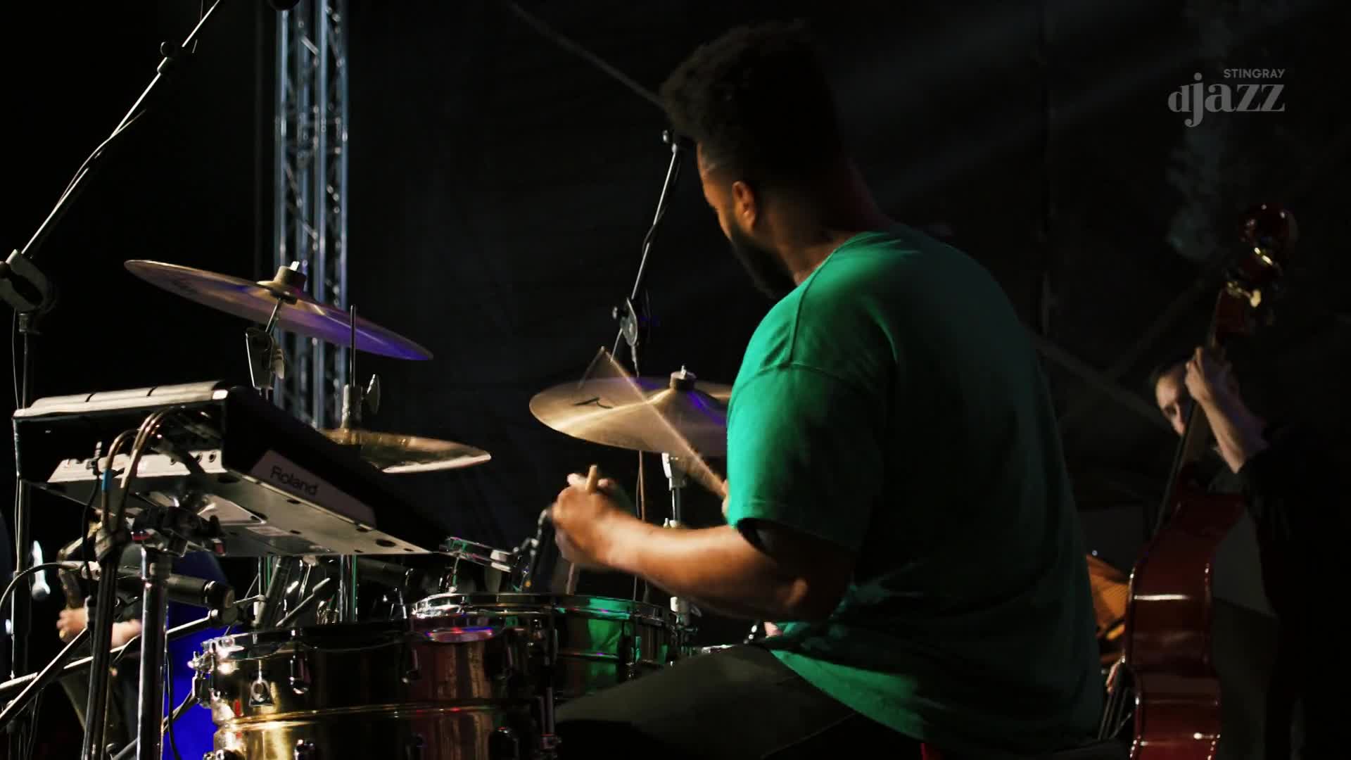 The drummer's sticks are a blur as he hits the cymbals, a deep bass line thrumming from the upright bass beside him. This is a Stingray DJAZZ performance, live from Canada.