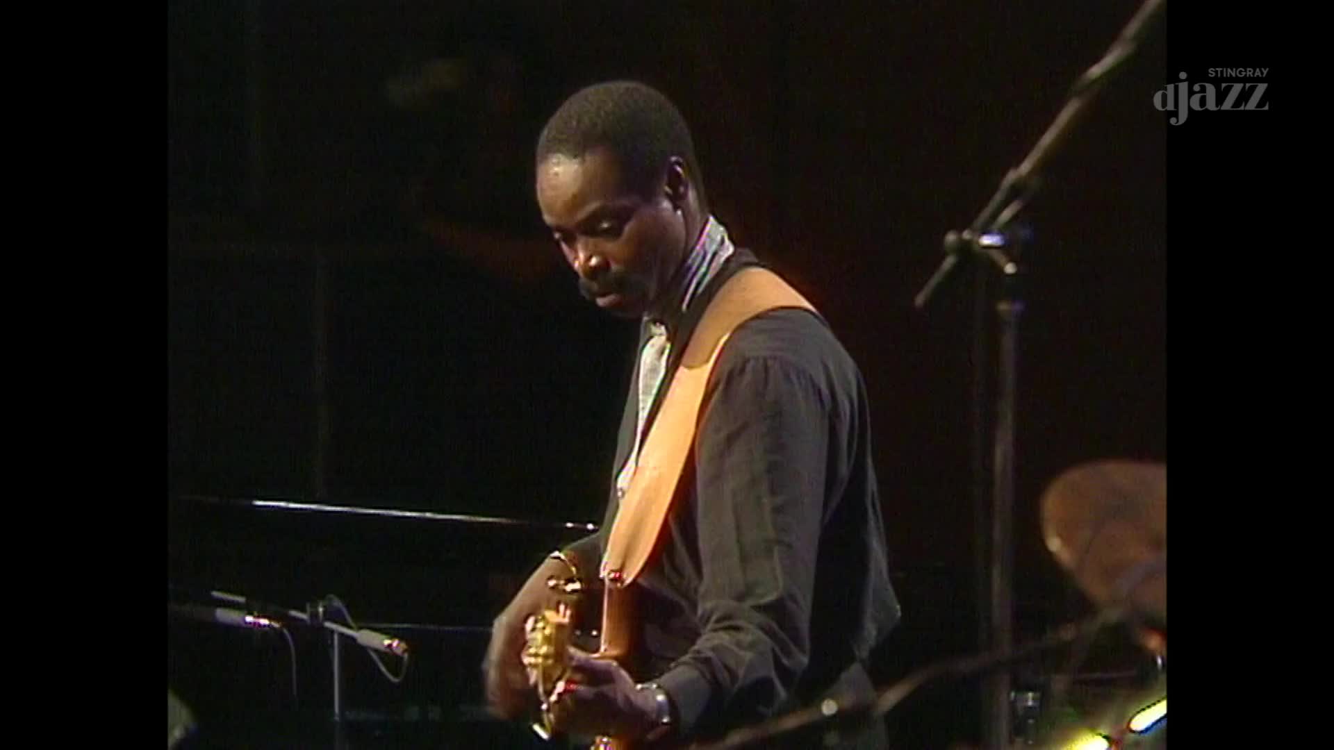 A bassist leans into his instrument, fingers dancing across the fretboard. The Stingray DJAZZ logo is visible in the corner, a reminder of the broadcast from Canada.