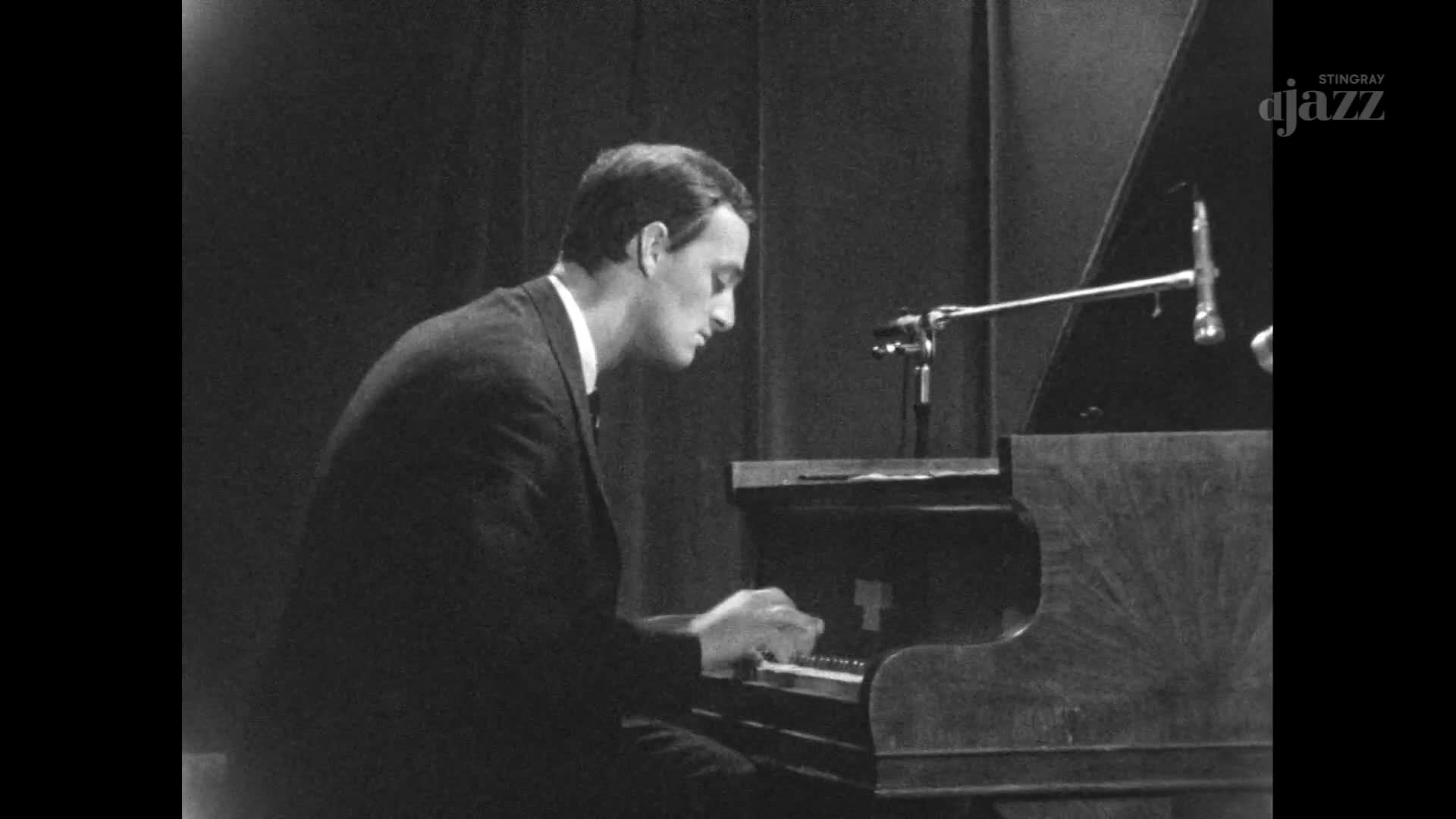 A man in a suit plays the piano, his fingers moving across the keys. The Stingray DJAZZ logo is visible in the corner, hinting at a Canadian broadcast.