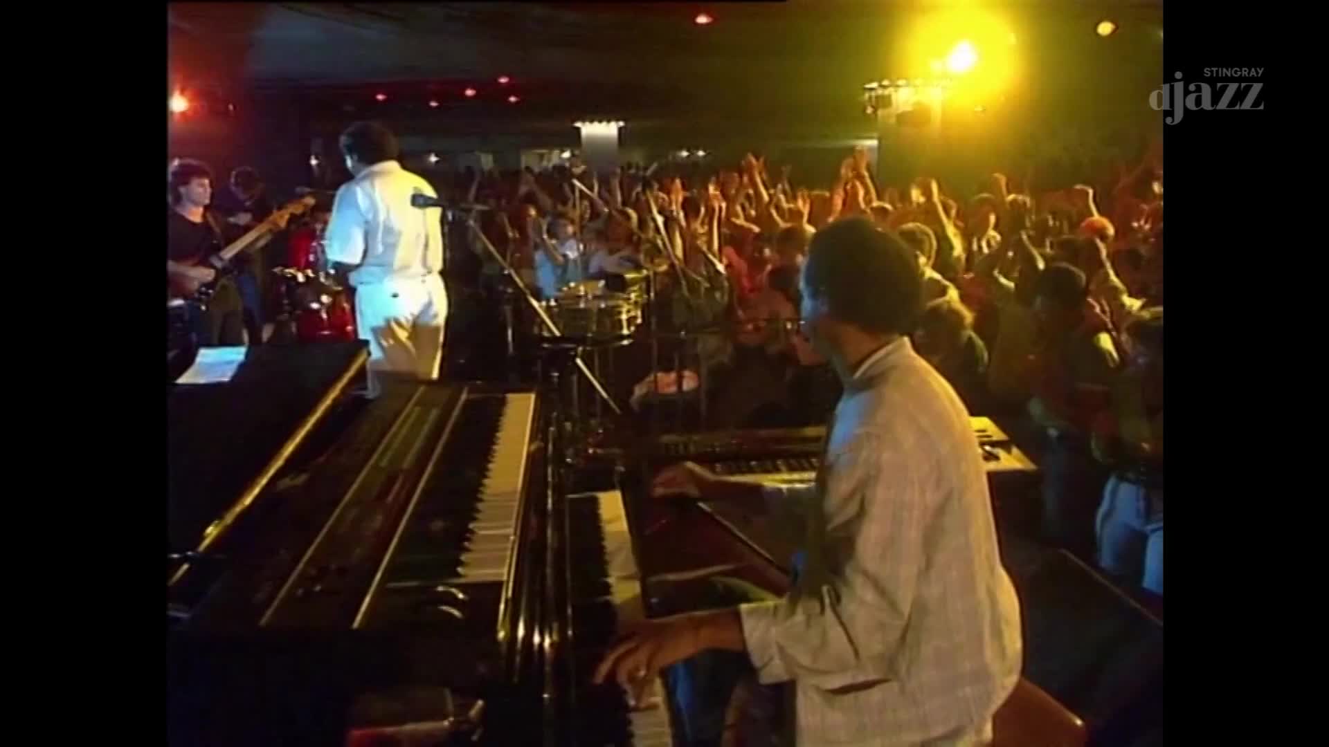 The pianist's fingers dance across the keys as the crowd in this Canadian venue roars their approval. A Stingray DJAZZ broadcast captures the energy of the live performance. The pianist's fingers dance across the keys as the crowd in this Canadian venue roars their approval. A Stingray DJAZZ broadcast captures the energy of the live performance.