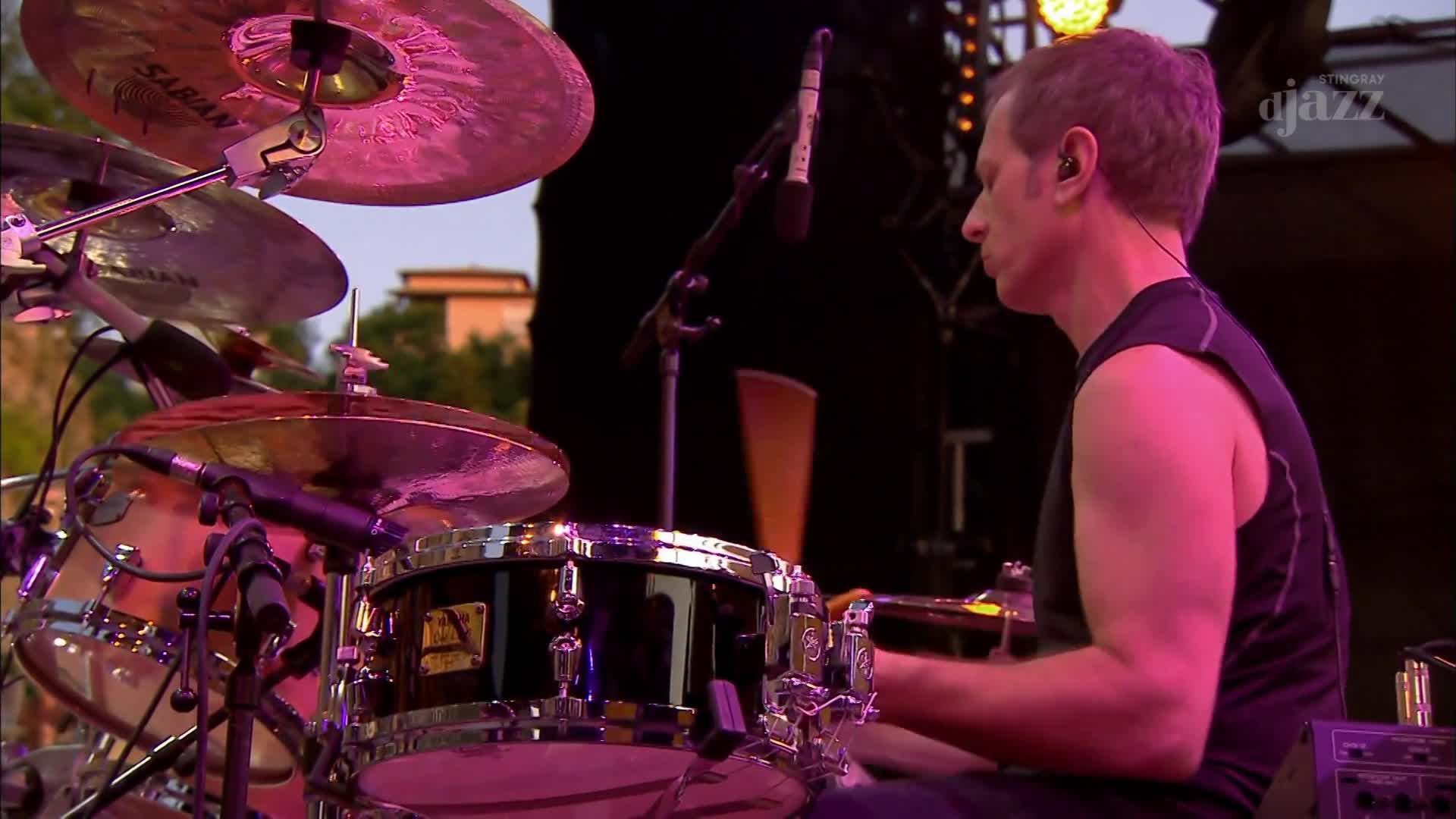 The drummer's sticks are a blur as he hits the snare, the cymbals shimmering under the stage lights. This is part of Stingray DJAZZ's broadcast from Canada. The drummer's sticks are a blur as he hits the snare, the cymbals shimmering under the stage lights. This is part of Stingray DJAZZ's broadcast from Canada.