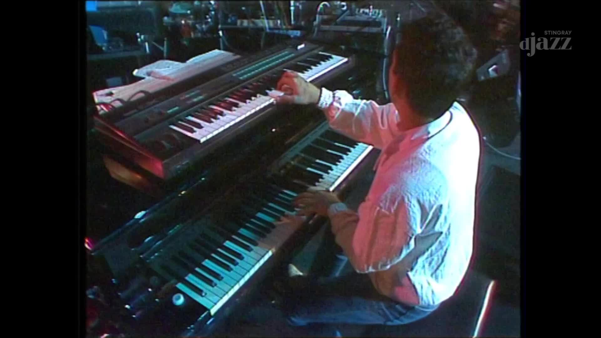 A musician in a white shirt plays two keyboards, his fingers dancing across the keys. The Stingray DJAZZ logo is visible in the corner, suggesting this performance is part of a Canadian broadcast.