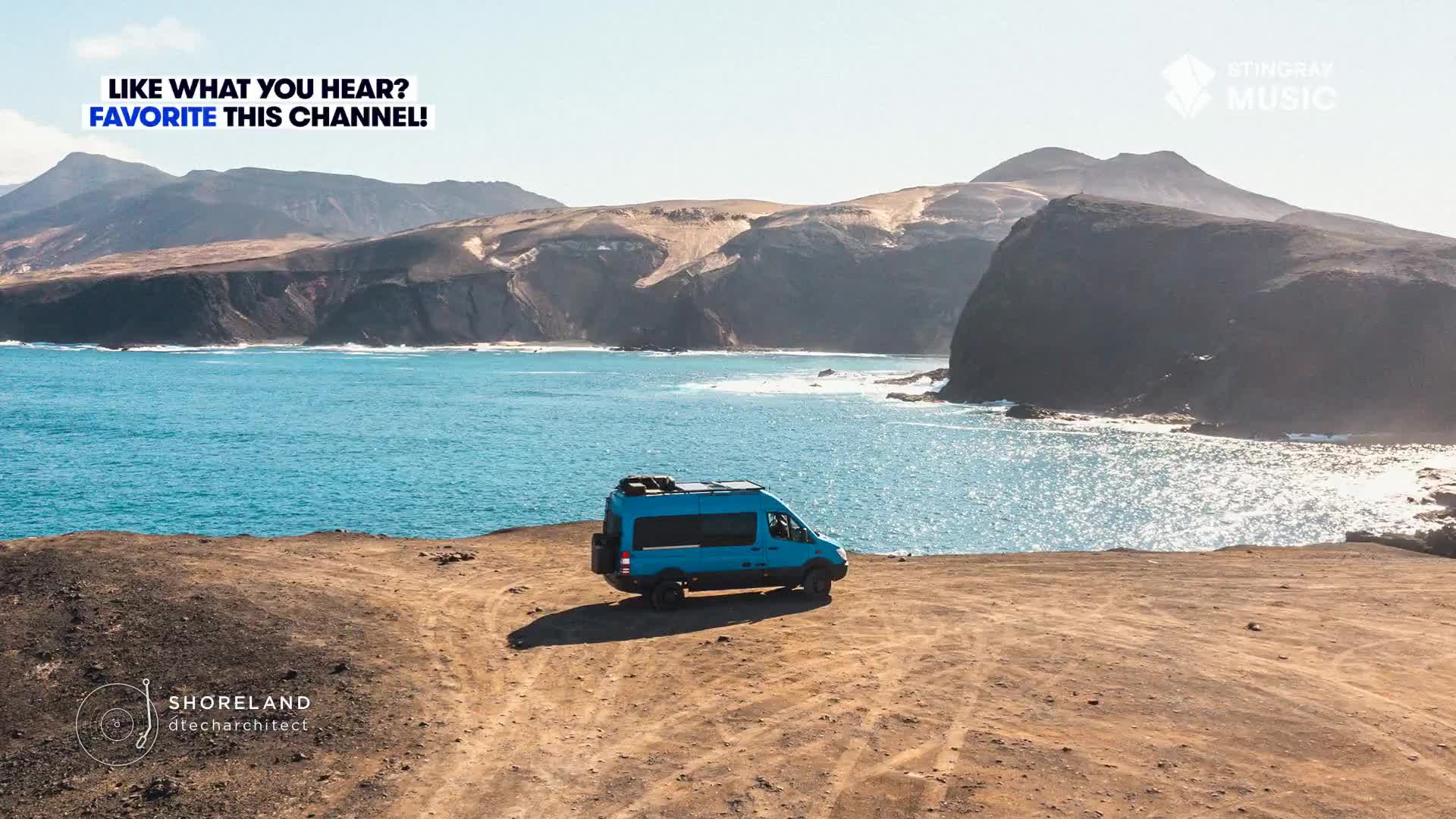 A blue van sits parked on a desolate cliffside, overlooking a turquoise ocean. The rugged coastline stretches out in the distance, bathed in sunlight, as if accompanying the easy listening tunes of Stingray Music.
