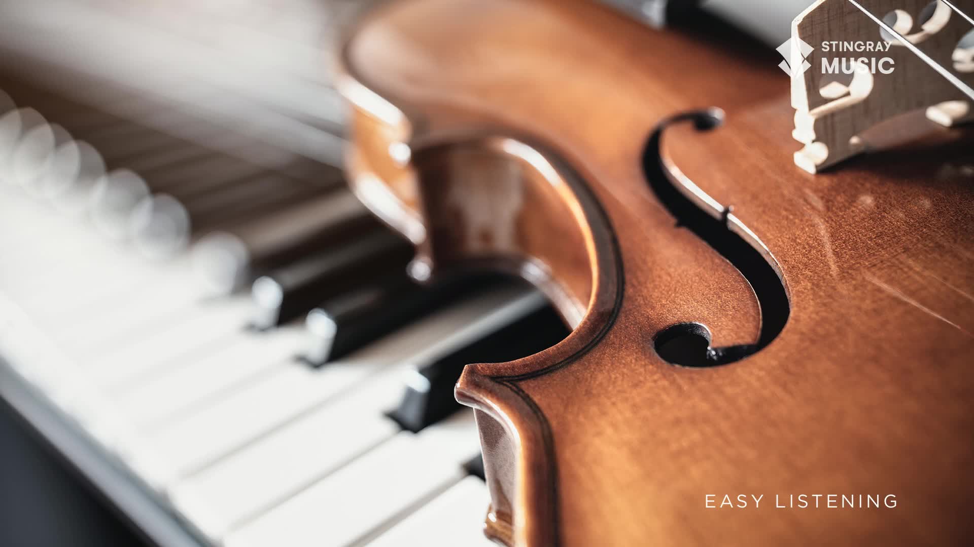 A violin rests on piano keys, its wooden body catching the light. The Stingray Music logo and "Easy Listening" text suggest a Canadian broadcast of mellow tunes.
