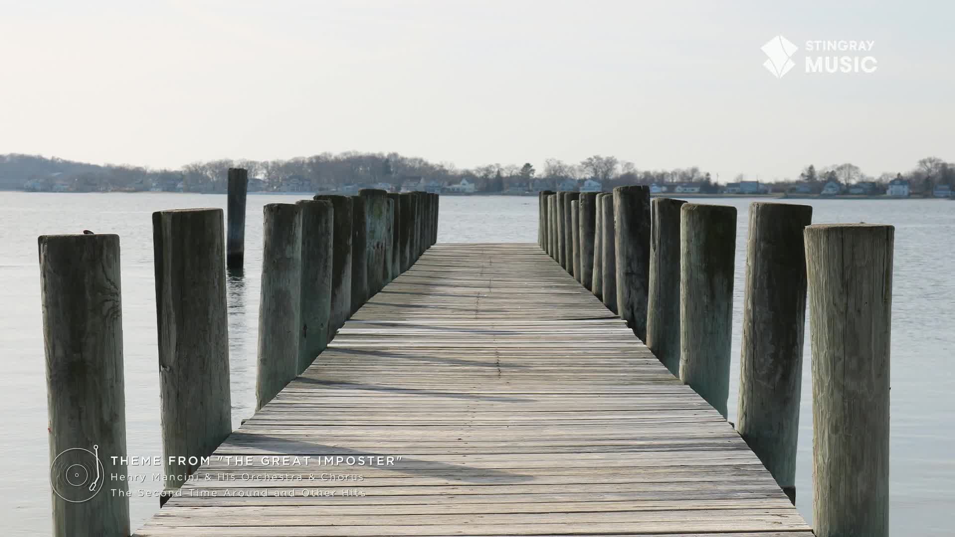 The weathered wooden planks of a pier stretch out towards the water, flanked by sturdy posts.  A gentle, Stingray Easy Listening vibe seems to emanate from the quiet scene in Canada.
