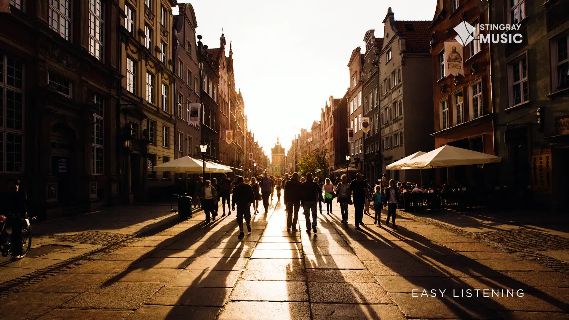 The sun is low, casting long shadows from the buildings and the people strolling down the cobblestone street. It's a perfect scene for Stingray Easy Listening, playing somewhere in the background.
