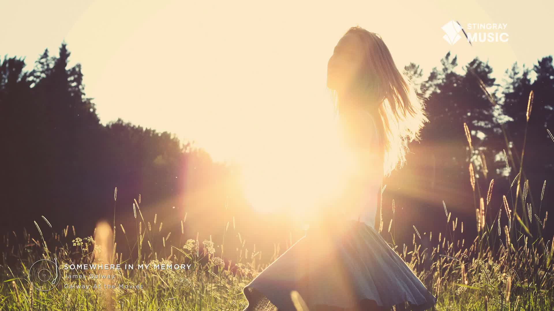 The sun is low, and a woman in a flowing skirt is spinning, her hair catching the light. The scene feels like a moment of freedom, reminiscent of the Stingray Easy Listening station from Canada.

