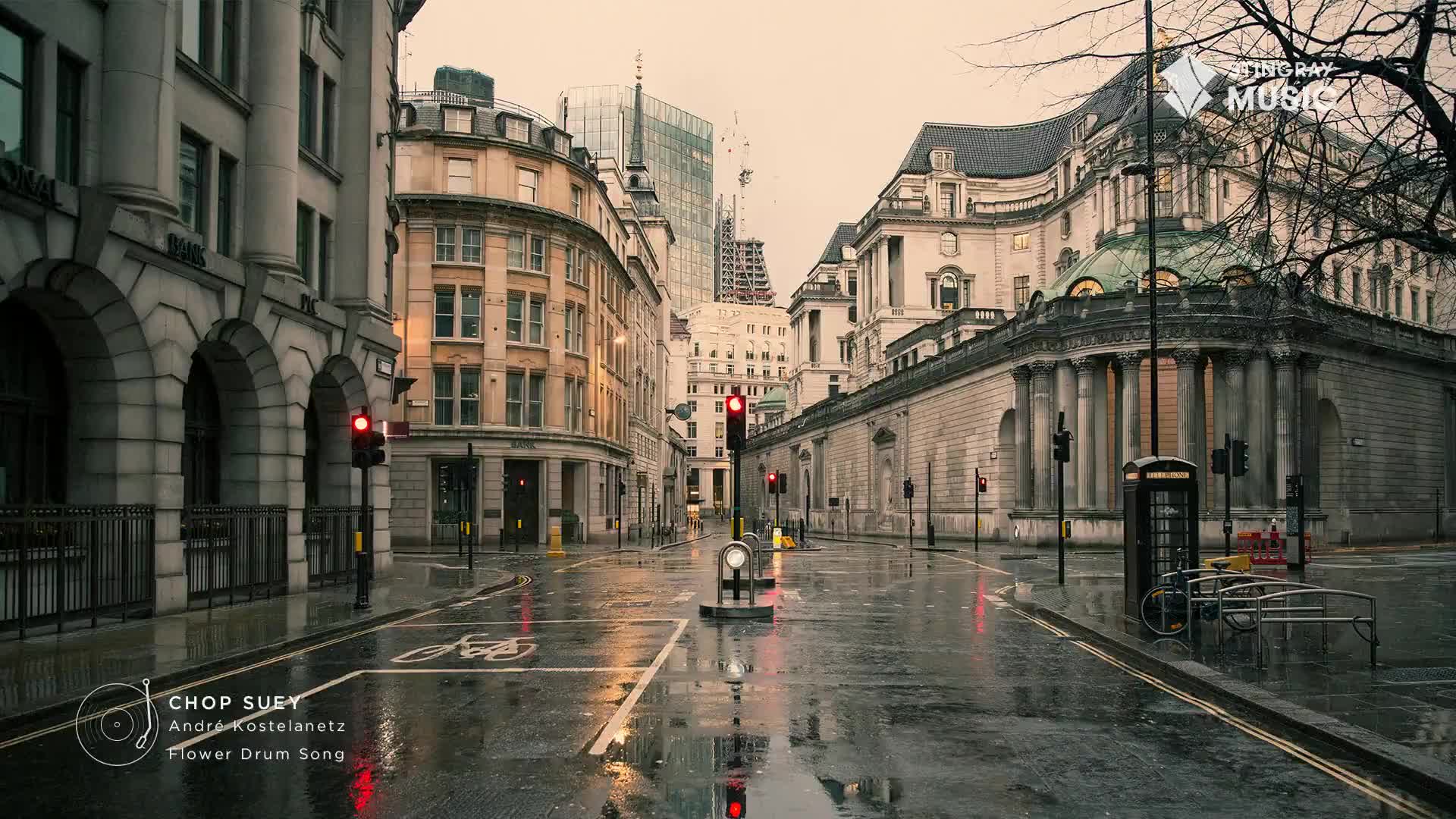 The wet street reflects the buildings, and the red traffic lights glow in the overcast light. It's the kind of day that makes me want to put on Stingray Easy Listening and stay inside.
