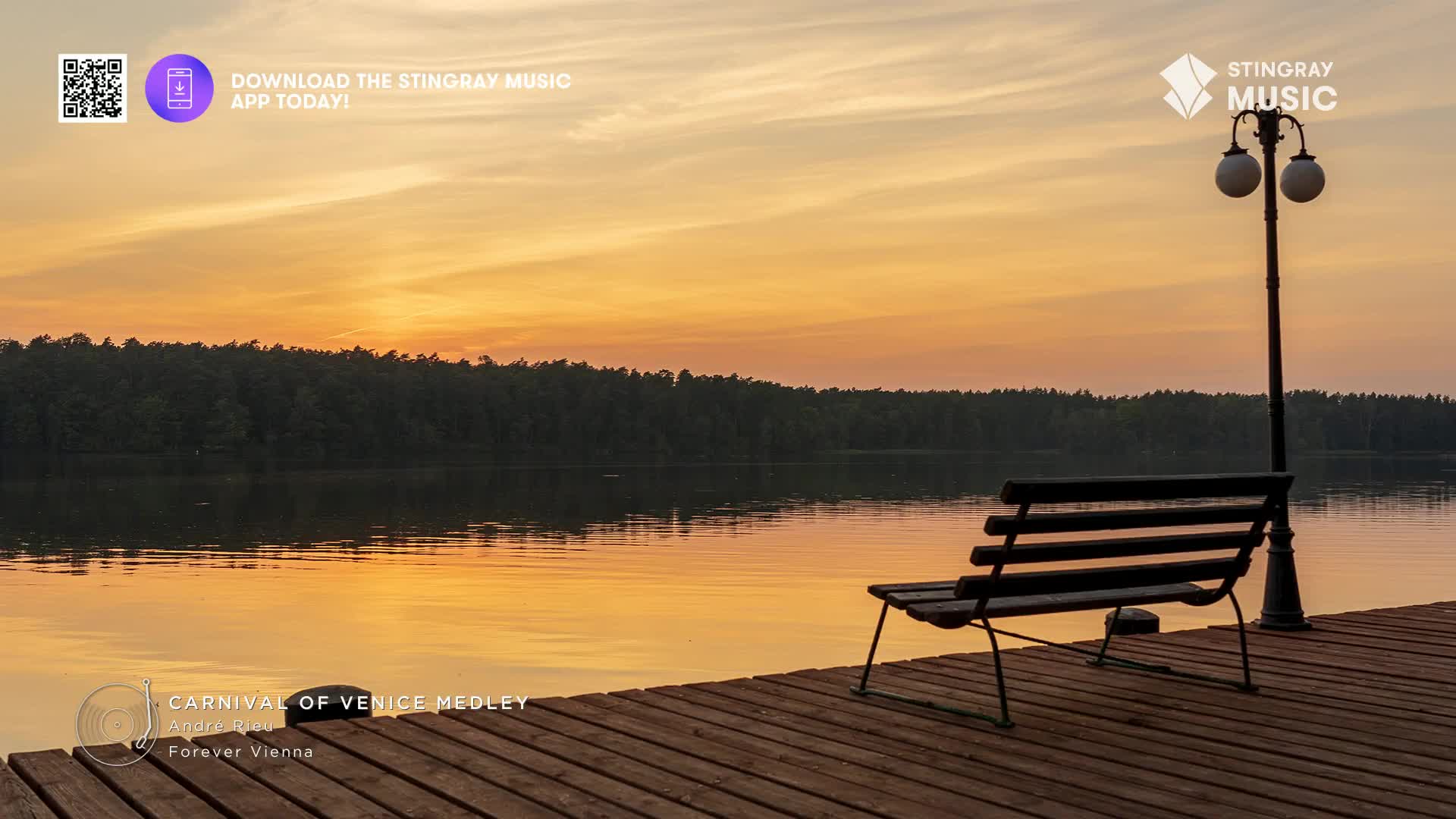 The sun is setting, painting the water and sky with warm colours. A bench sits empty on a wooden dock, overlooking the calm lake.
The sun is setting, painting the water and sky with warm colours. A bench sits empty on a wooden dock, overlooking the calm lake.