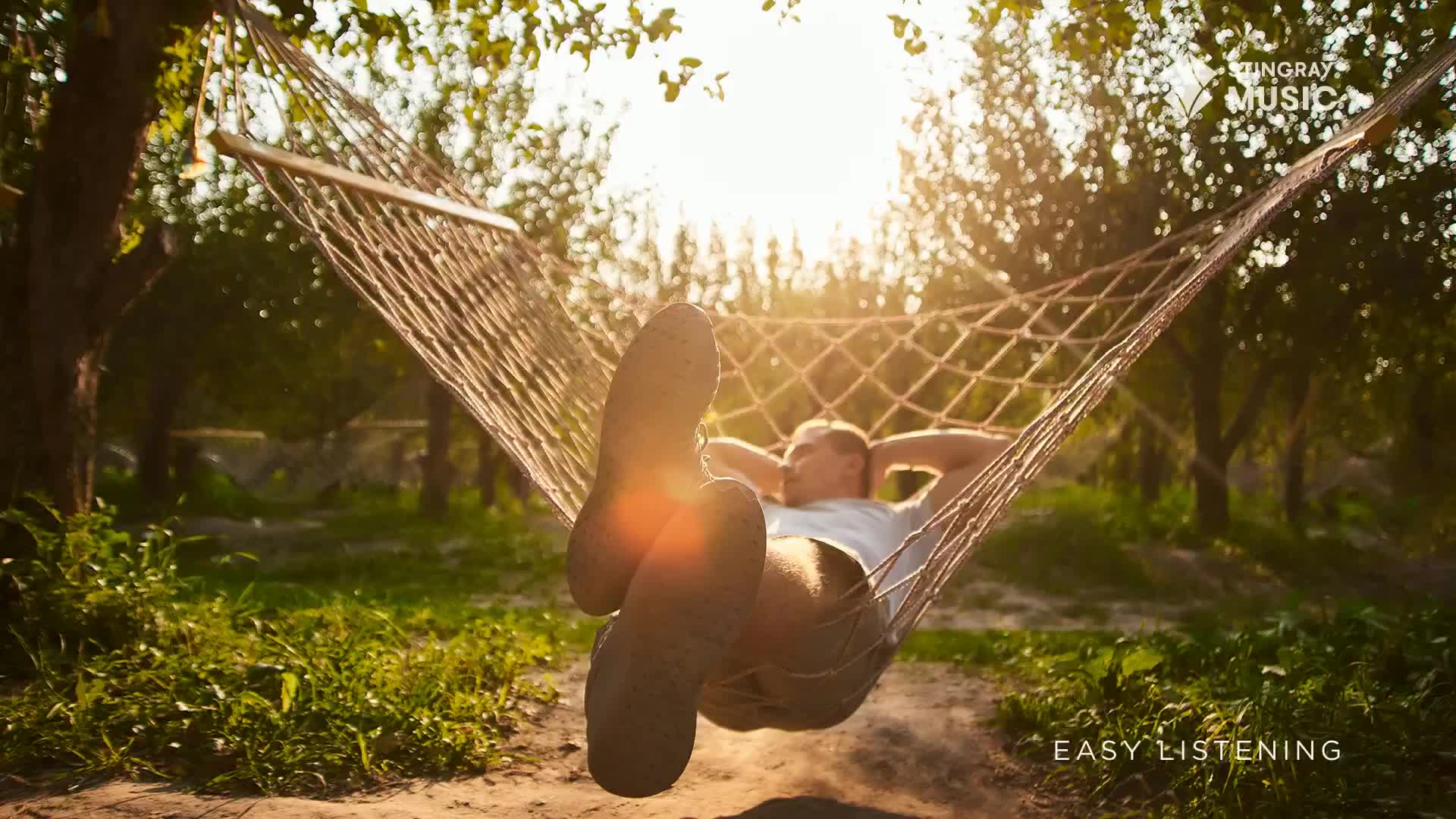 The sun shines through the trees as a person rests in a hammock, their feet silhouetted against the light. Easy listening music from Stingray in Canada seems like the perfect soundtrack for this peaceful moment.
The sun shines through the trees as a person rests in a hammock, their feet silhouetted against the light. Easy listening music from Stingray in Canada seems like the perfect soundtrack for this peaceful moment.