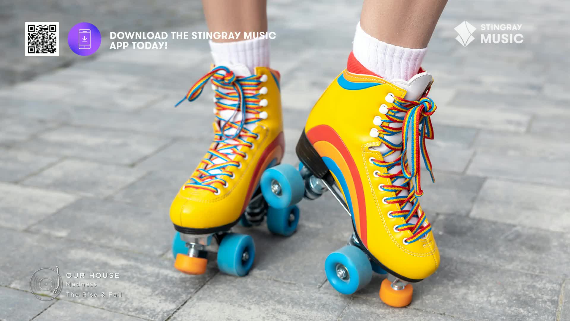 Bright yellow roller skates with rainbow stripes and laces are on display. The skates sit on a grey brick surface, a perfect match for the Stingray Music app and the '80s vibe.
