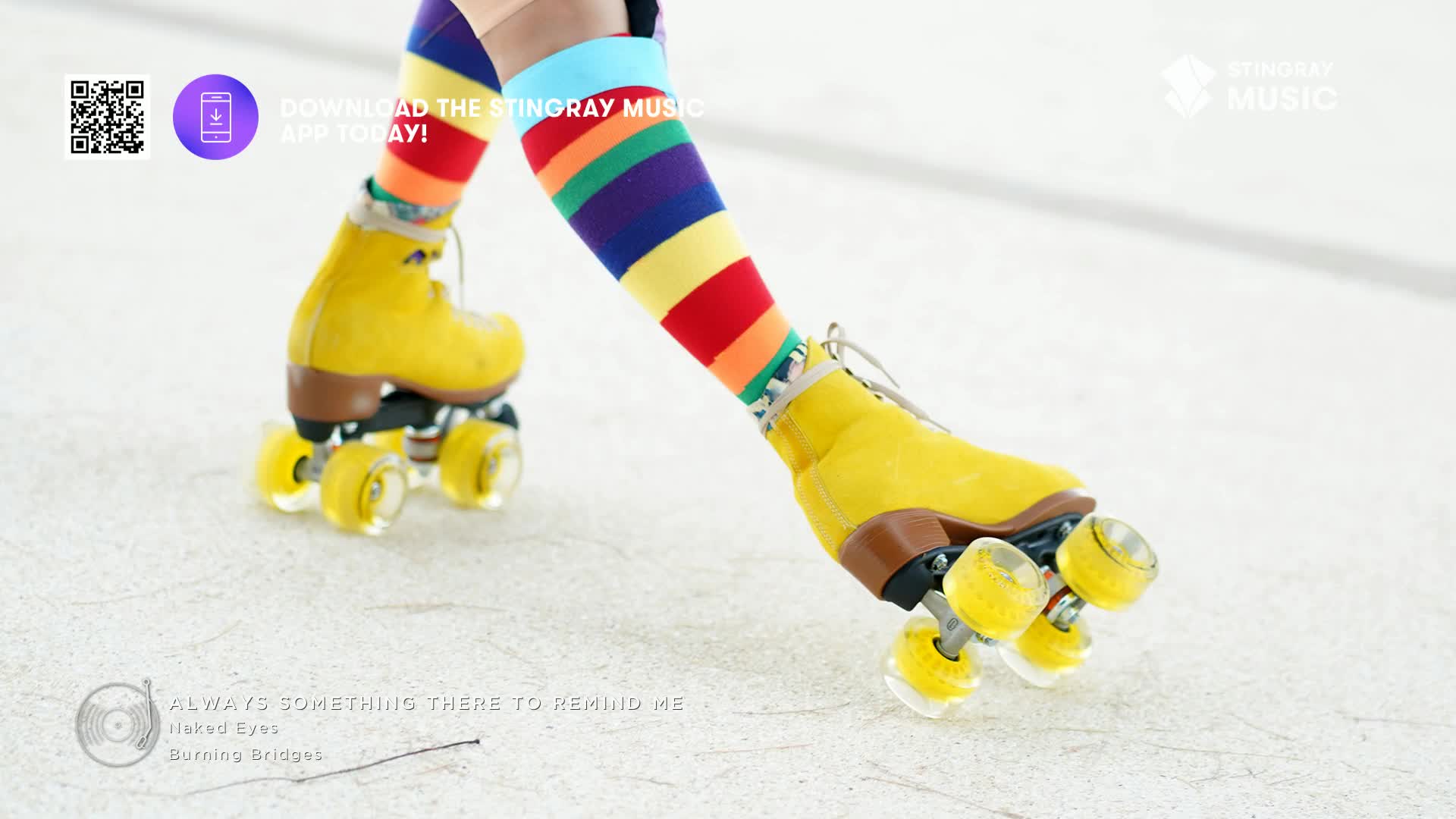 Bright yellow roller skates glide across a white surface, the wheels catching the light. Rainbow-striped socks peek out from the skates, a vibrant contrast to the muted background.
