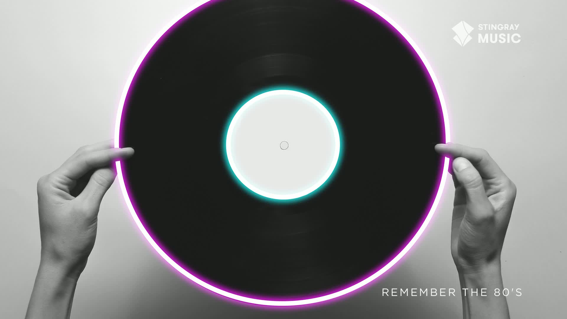 A black vinyl record, framed by a glowing purple and teal outline, is held gently by two hands. The Stingray Music logo and the words "Remember the 80's" are visible, a nod to the Canadian music scene.
